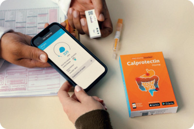 A doctor shows a patient the SmarTest Calprotectin fecal test for IBD remote monitoring, to reduce the number of patient visits.