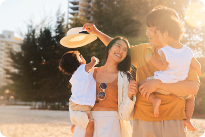 A family with two children is enjoying the sun on the beach during their summer vacation to get some vitamin D.